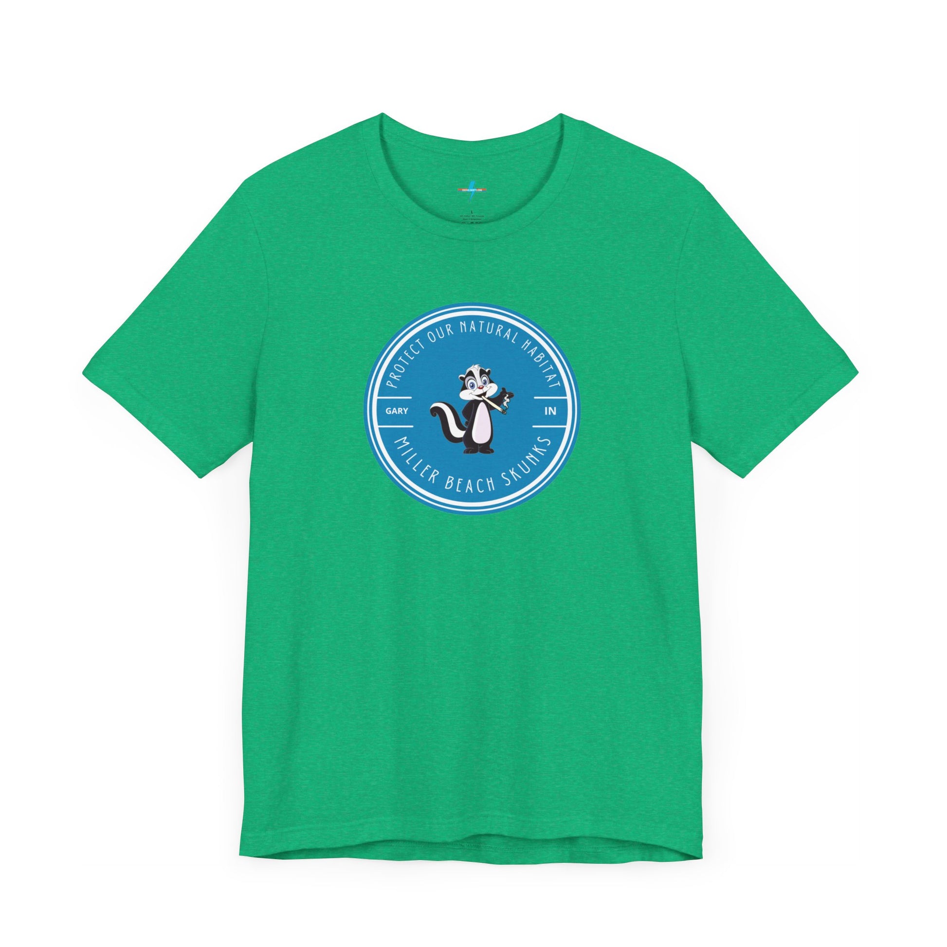 The Printify Miller Beach Skunks - Unisex Jersey Short Sleeve Tee is a gray T-shirt that features a circular blue logo at the center. Inside the logo, there is an illustration of a skunk with the text "Protect Our Habitat" and "Miller Beach Skunks" around the border, promoting environmental consciousness. The upper left part of the logo reads "Gary, IN.