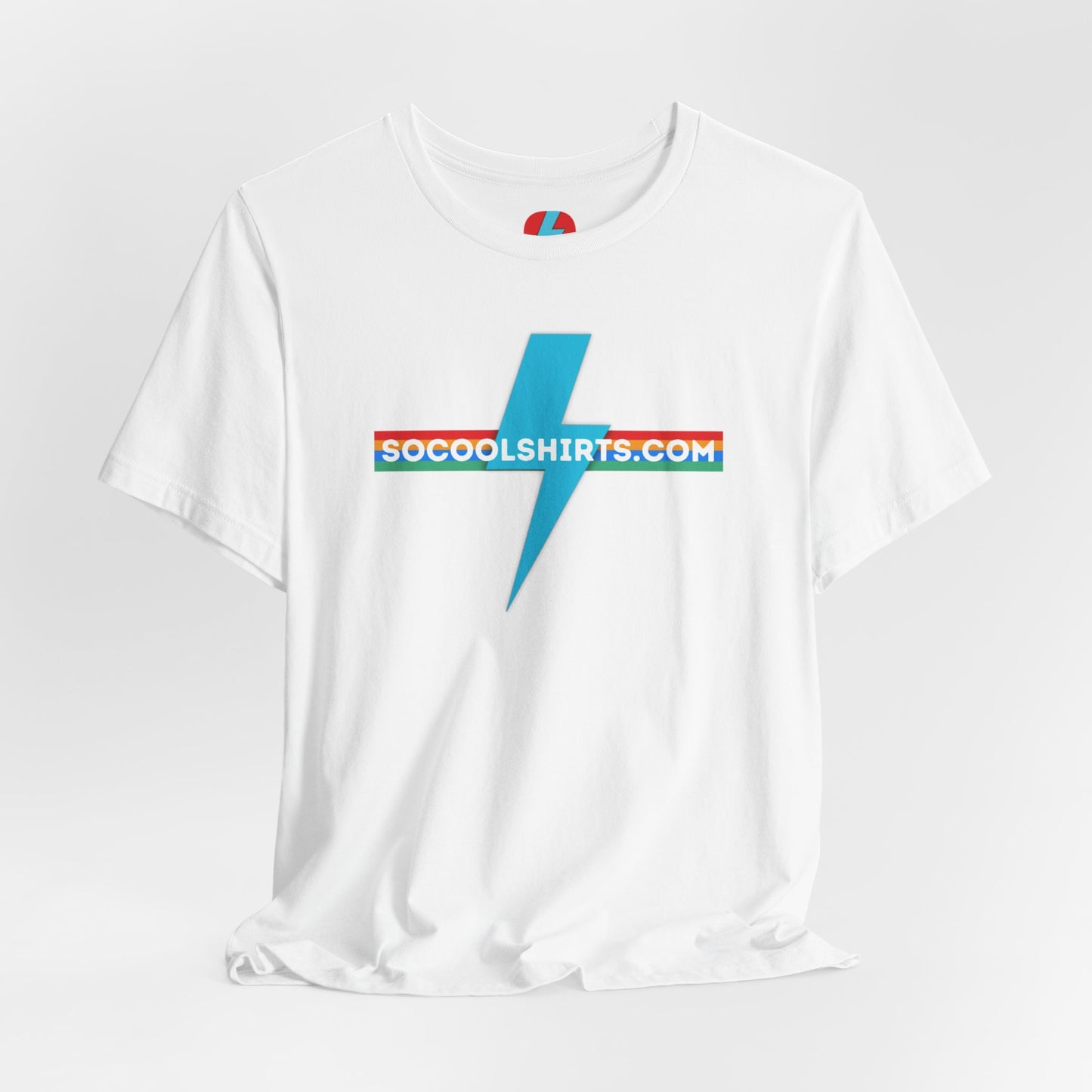 This unisex jersey short sleeve tee by Printify features a striking maroon color with a central light blue lightning bolt design. The text "SOCOOLSHIRTS.COM" is prominently displayed across the lightning bolt in white letters, set against a multicolored background that exudes retro vibes. The shirt is shown laid flat on a white backdrop.