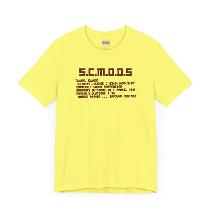 Two yellow "S.C.M.O.D.S. Blues Brother's - Unisex Jersey Short Sleeve Tee" shirts from Printify, featuring "S.C.M.O.D.S" in bold, stylized letters along with smaller text detailing terms like "Illinois," "license," and "impound vehicle." Perfect for fans of The Blues Brothers and Jake and Elwood Blues, the T-shirts are neatly folded and stacked.