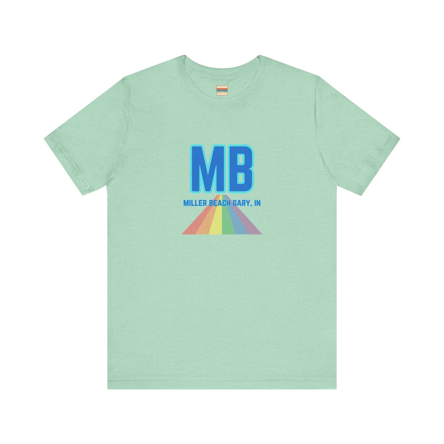 The Miller Beach Pride - Unisex Jersey Short Sleeve Tee by Printify is a white shirt made from 100% Airlume combed cotton. It showcases a design with large, bold blue letters "MB" at the top. Beneath it, the text "MILLER BEACH GARY, IN" is written in blue. A colorful, triangular rainbow graphic extends downward from the text, symbolizing Miller Beach pride.