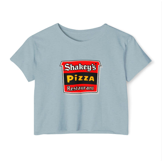 The Shakey's Pizza - Women's Festival Crop Top from Printify is a light blue garment that proudly displays the iconic Shakey's Pizza logo on the chest. Featuring retro-style red and black signage with text in white, yellow, and red that reads "Shakey's Pizza Restaurant," this crop top exudes a vintage-inspired charm.