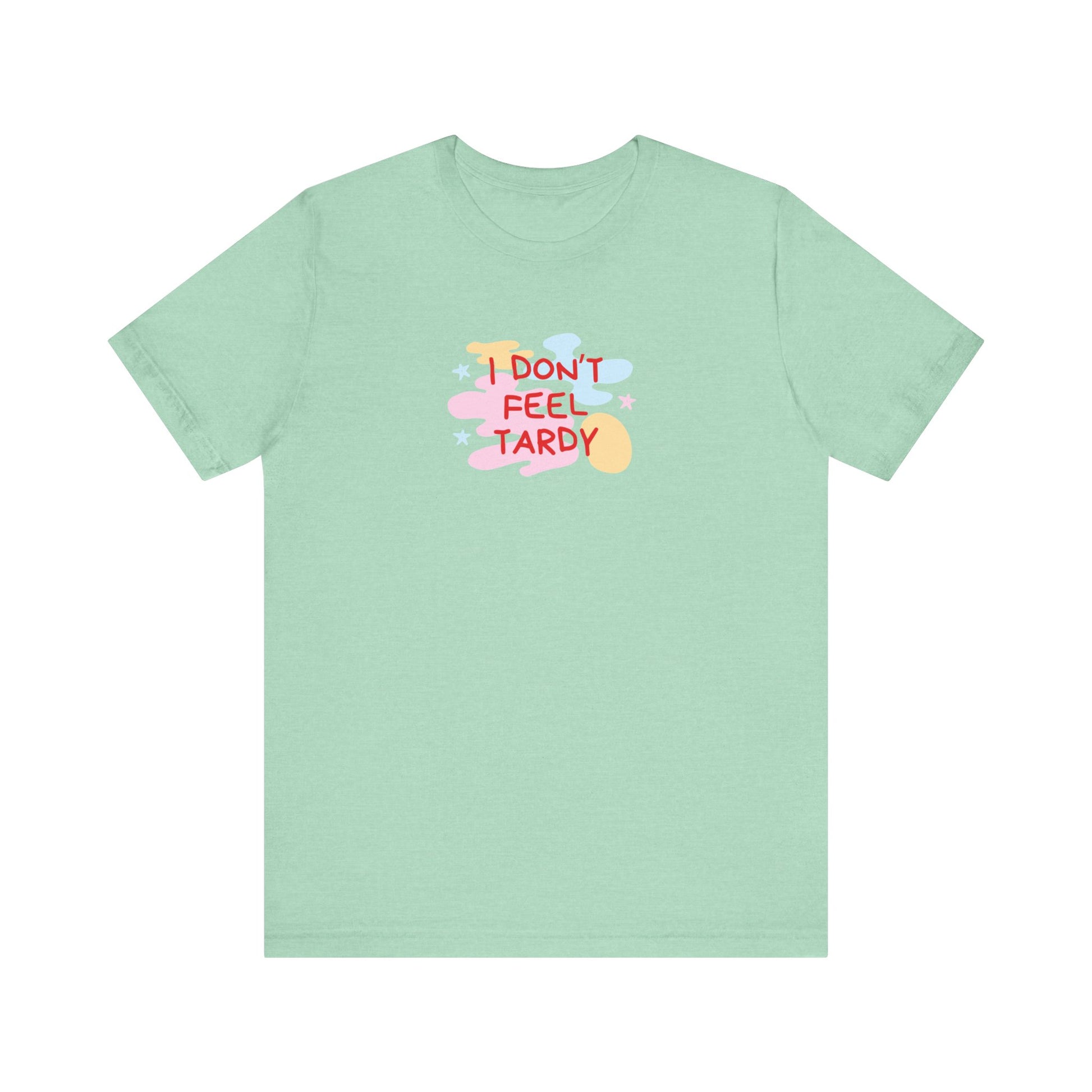 The "I Don't Feel Tardy - 1980s Retro - Unisex Jersey Short Sleeve Tee" from Printify is a light pink jersey shirt that features the bold, colorful text "I DON'T FEEL TARDY" prominently at its center. This design exudes retro vibes with small star shapes and abstract splashes of blue, yellow, and pink, laid flat against a plain background to channel pure Van Halen T-shirt energy.