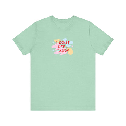 The "I Don't Feel Tardy - 1980s Retro - Unisex Jersey Short Sleeve Tee" from Printify is a light pink jersey shirt that features the bold, colorful text "I DON'T FEEL TARDY" prominently at its center. This design exudes retro vibes with small star shapes and abstract splashes of blue, yellow, and pink, laid flat against a plain background to channel pure Van Halen T-shirt energy.