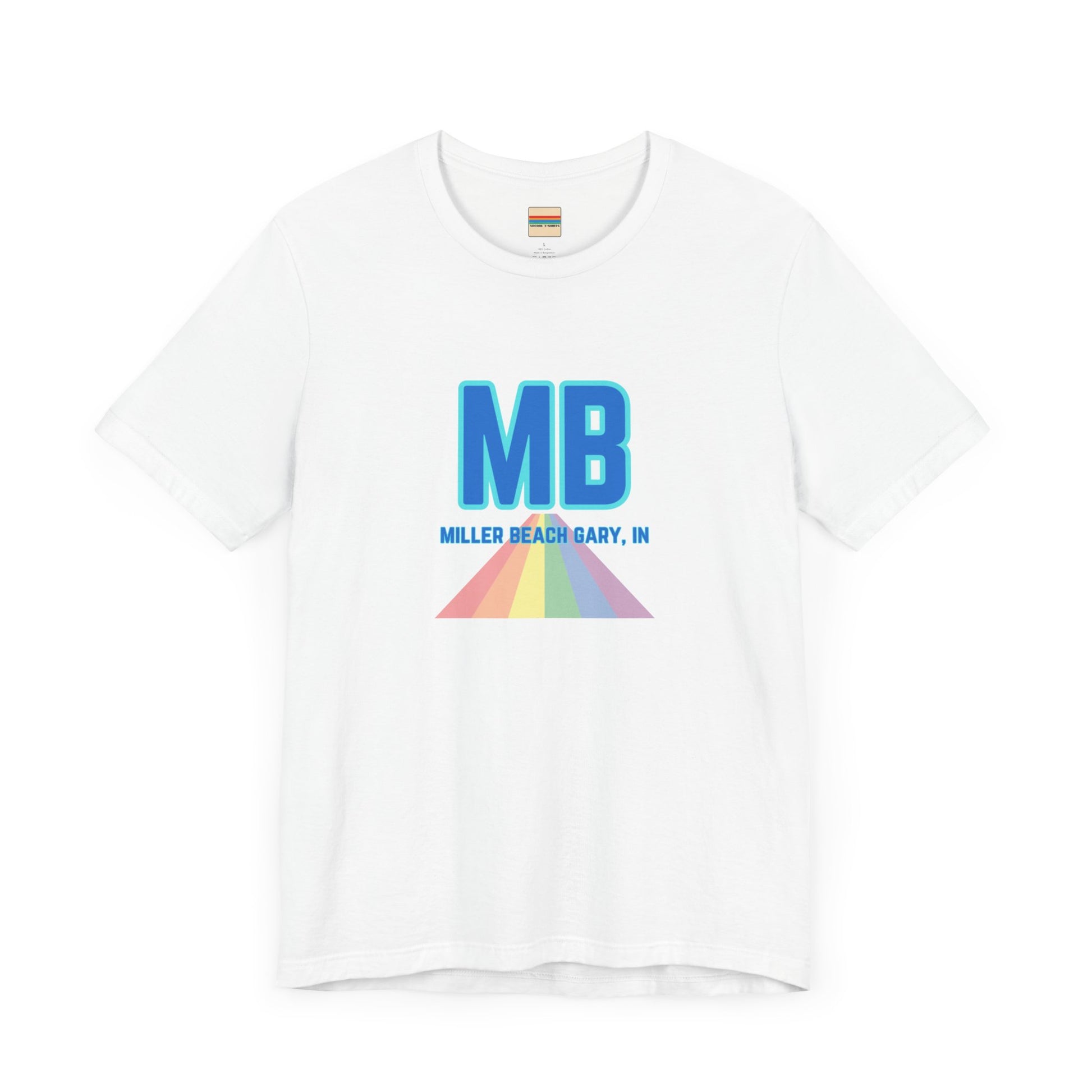 The Miller Beach Pride - Unisex Jersey Short Sleeve Tee by Printify is a white shirt made from 100% Airlume combed cotton. It showcases a design with large, bold blue letters "MB" at the top. Beneath it, the text "MILLER BEACH GARY, IN" is written in blue. A colorful, triangular rainbow graphic extends downward from the text, symbolizing Miller Beach pride.