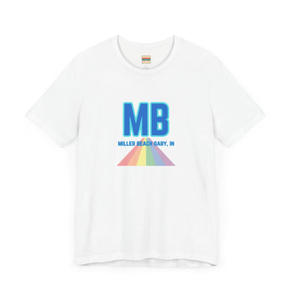 The Miller Beach Pride - Unisex Jersey Short Sleeve Tee by Printify is a white shirt made from 100% Airlume combed cotton. It showcases a design with large, bold blue letters "MB" at the top. Beneath it, the text "MILLER BEACH GARY, IN" is written in blue. A colorful, triangular rainbow graphic extends downward from the text, symbolizing Miller Beach pride.