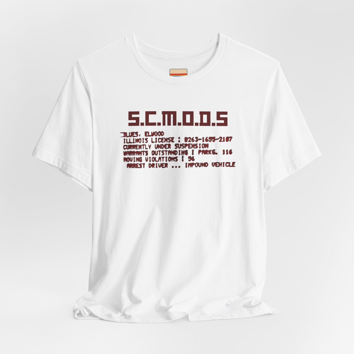 Two yellow "S.C.M.O.D.S. Blues Brother's - Unisex Jersey Short Sleeve Tee" shirts from Printify, featuring "S.C.M.O.D.S" in bold, stylized letters along with smaller text detailing terms like "Illinois," "license," and "impound vehicle." Perfect for fans of The Blues Brothers and Jake and Elwood Blues, the T-shirts are neatly folded and stacked.