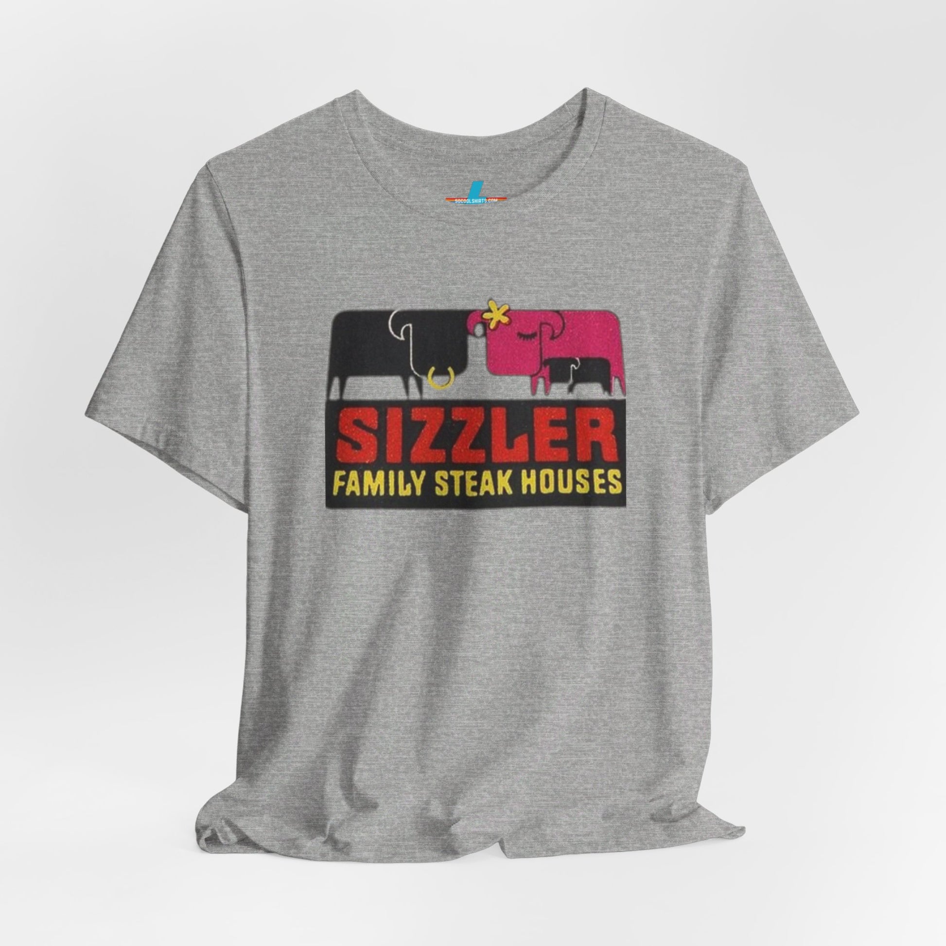 The "Sizzler Family Steakhouses - Retro 1981 Logo - Unisex Jersey Short Sleeve Tee" by Printify is a gray t-shirt showcasing a retro-style graphic with two black and pink cows, a cactus, and the text "Sizzler Family Steak Houses" in vibrant red and yellow. Ideal for any retro enthusiast, this design evokes nostalgia reminiscent of vintage restaurant logos from 1981.