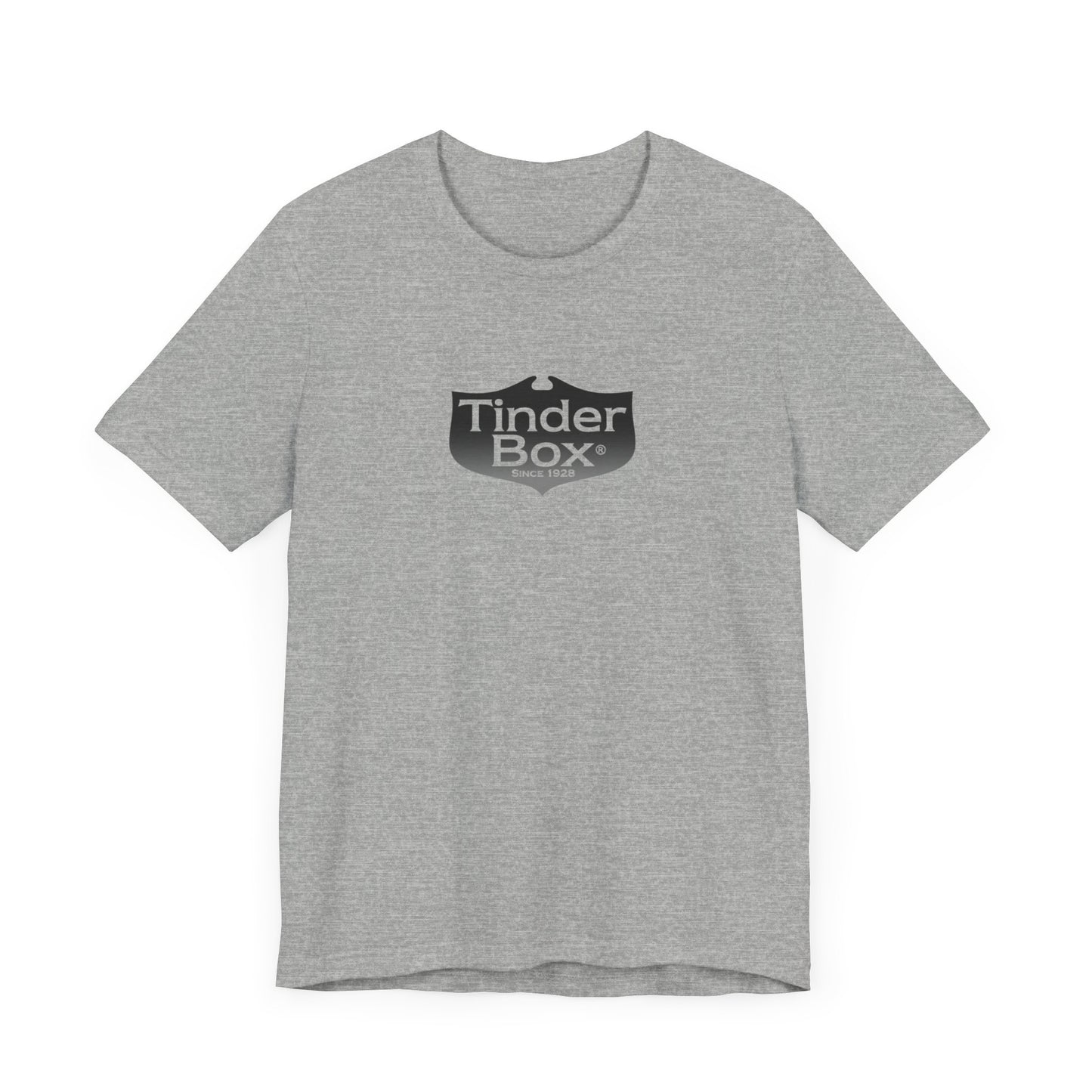 A light blue Printify "The Tinder Box 1980s" unisex jersey short sleeve tee featuring the "Tinder Box" logo in the center. The logo consists of a dark shield with the words "Tinder Box" in white text, with a small flame icon replacing the dot above the "i".