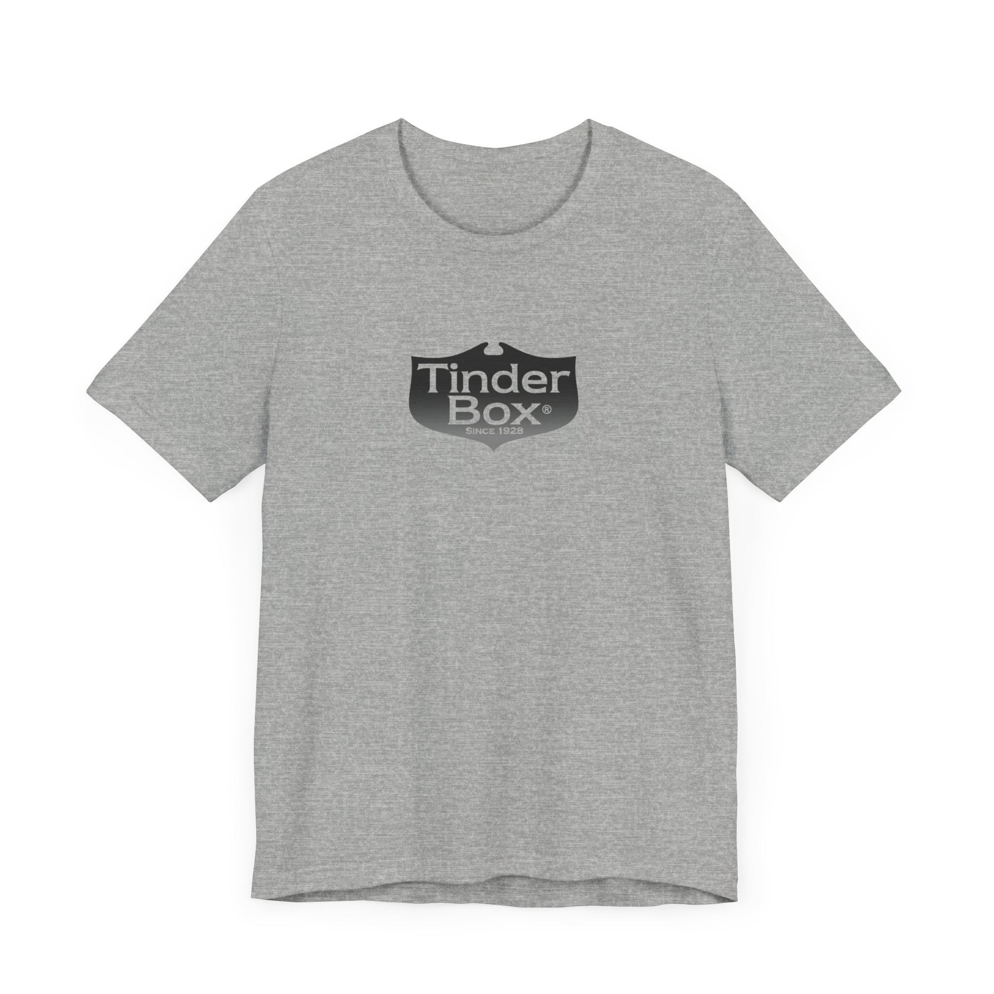 A light blue Printify "The Tinder Box 1980s" unisex jersey short sleeve tee featuring the "Tinder Box" logo in the center. The logo consists of a dark shield with the words "Tinder Box" in white text, with a small flame icon replacing the dot above the "i".
