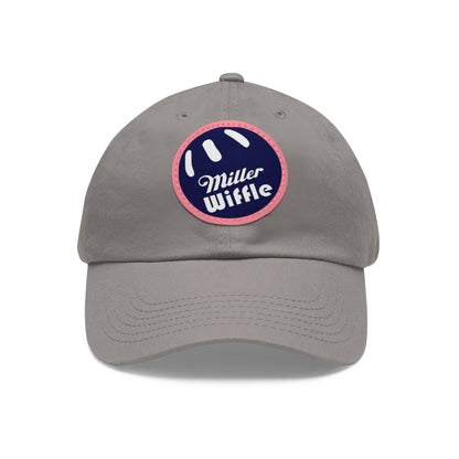 A gray dad hat by Printify, crafted from bio-washed chino twill, featuring a circular blue and white leather patch on the front. The patch showcases a baseball design with "Miller Wiffle" written in cursive font.