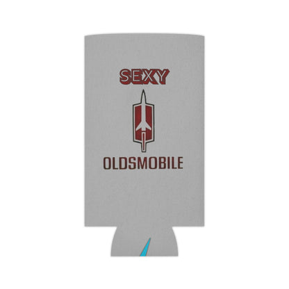 The Sexy Oldsmobile Koozie by Printify features "SEXY" in red at the top on a gray background, followed by the Oldsmobile logo and the word "OLDSMOBILE" below it. At the bottom, there's a blue and red logo reading "SOCOOLSHIRTS.COM." This koozie has an indentation designed to hold a can securely.