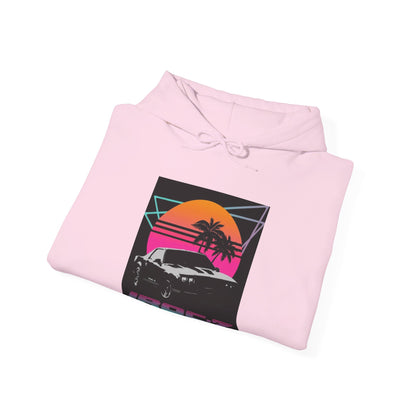 Introducing the Chevrolet IRoc Z28 - 1980s Retro Hoodie by Printify: This vibrant pink hoodie showcases a striking retro design on the front, featuring a classic American muscle car set against an orange and red sunset with palm trees, intersected by geometric shapes. The text "IROCZ" is prominently displayed below the image. Offering a relaxed fit and equipped with a front pocket, this hoodie perfectly captures the essence of 1980s style.