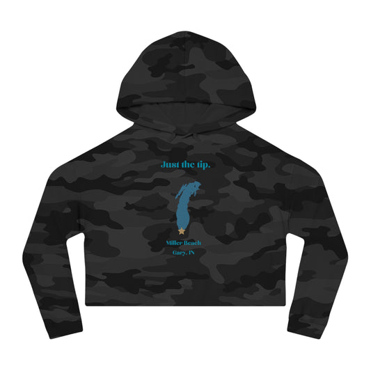 The "Just the Tip - Miller Beach - Women’s Cropped Hooded Sweatshirt" by Printify is designed in black camo with high-quality tri-blend fabric, showcasing a blue map shape and a yellow star. It features the phrase "Killer Beach" along with references to "Gary, IN," embodying the spirit of Miller Beach adventures.