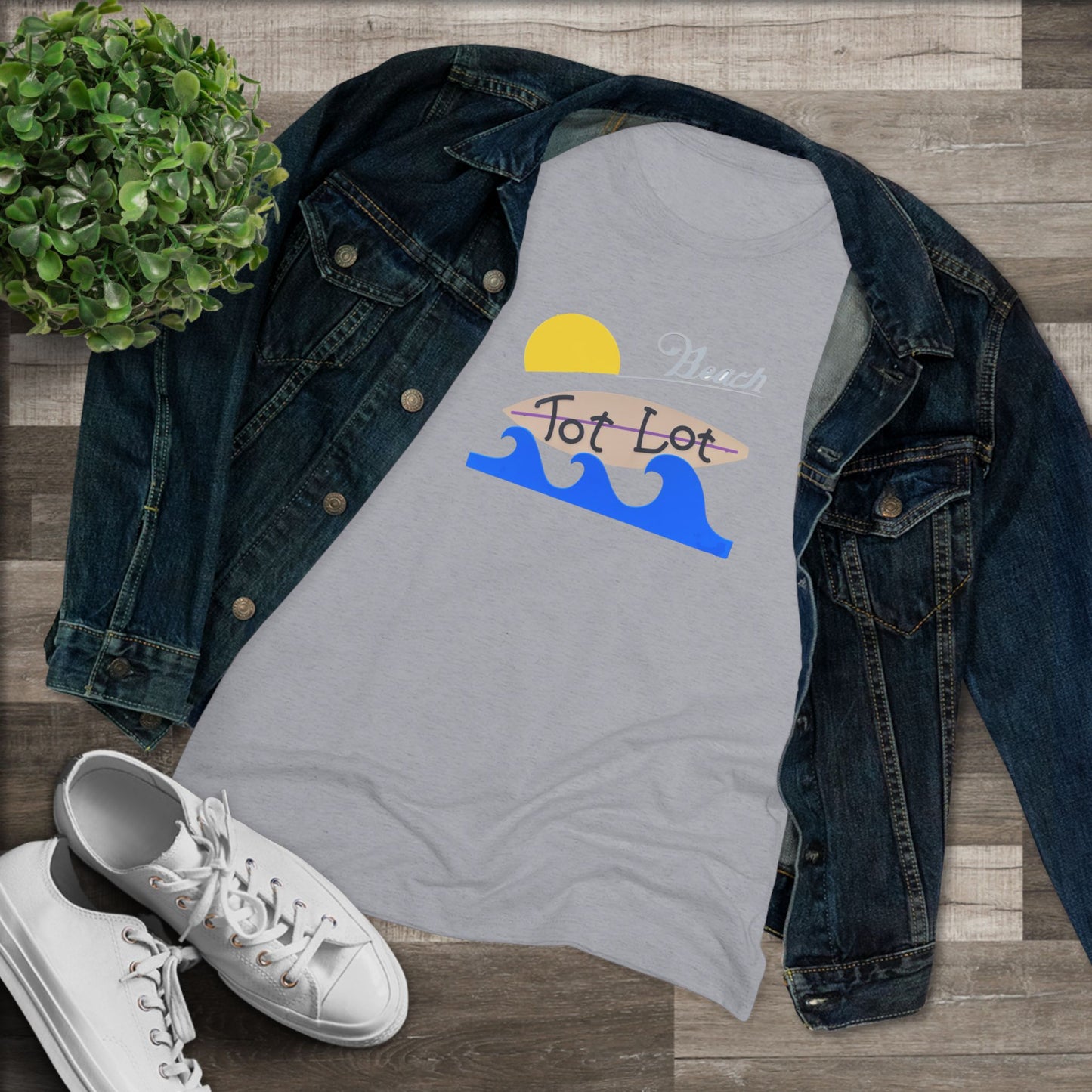 Introducing the Tot Lot Full Sign - Miller Beach - Women's Triblend Tee by Printify! This stylish gray t-shirt features a vintage-inspired design showcasing a setting sun, a surging blue wave, and the phrase "Miller Beach Tot Lot" in eye-catching stylized fonts. Perfect for any casual outing, this beach-themed top exudes a playful and trendy vibe.