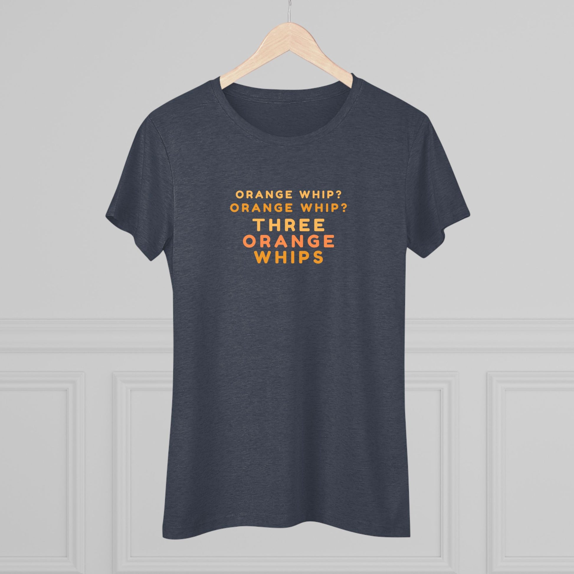 This Blues Brothers women's triblend tee from Printify features a dark gray vintage look with the text "ORANGE WHIP? ORANGE WHIP? THREE ORANGE WHIPS" printed in bright orange and yellow in the center. With a round neck and short sleeves, it's perfect for that retro vibe.