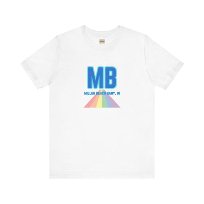 The Miller Beach Pride - Unisex Jersey Short Sleeve Tee by Printify is a white shirt made from 100% Airlume combed cotton. It showcases a design with large, bold blue letters "MB" at the top. Beneath it, the text "MILLER BEACH GARY, IN" is written in blue. A colorful, triangular rainbow graphic extends downward from the text, symbolizing Miller Beach pride.