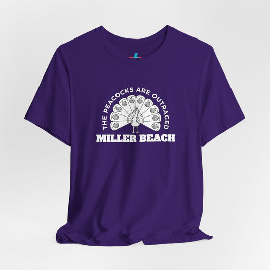 The Printify "The Peacocks are Outraged - Miller Beach - Unisex Jersey Short Sleeve Tee" is a purple T-shirt made of soft cotton, displaying a white peacock graphic in the center. Text around the peacock reads "THE PEACOCKS ARE OUTRAGED," and below the graphic, it proudly declares "MILLER BEACH," celebrating the vibrant community.