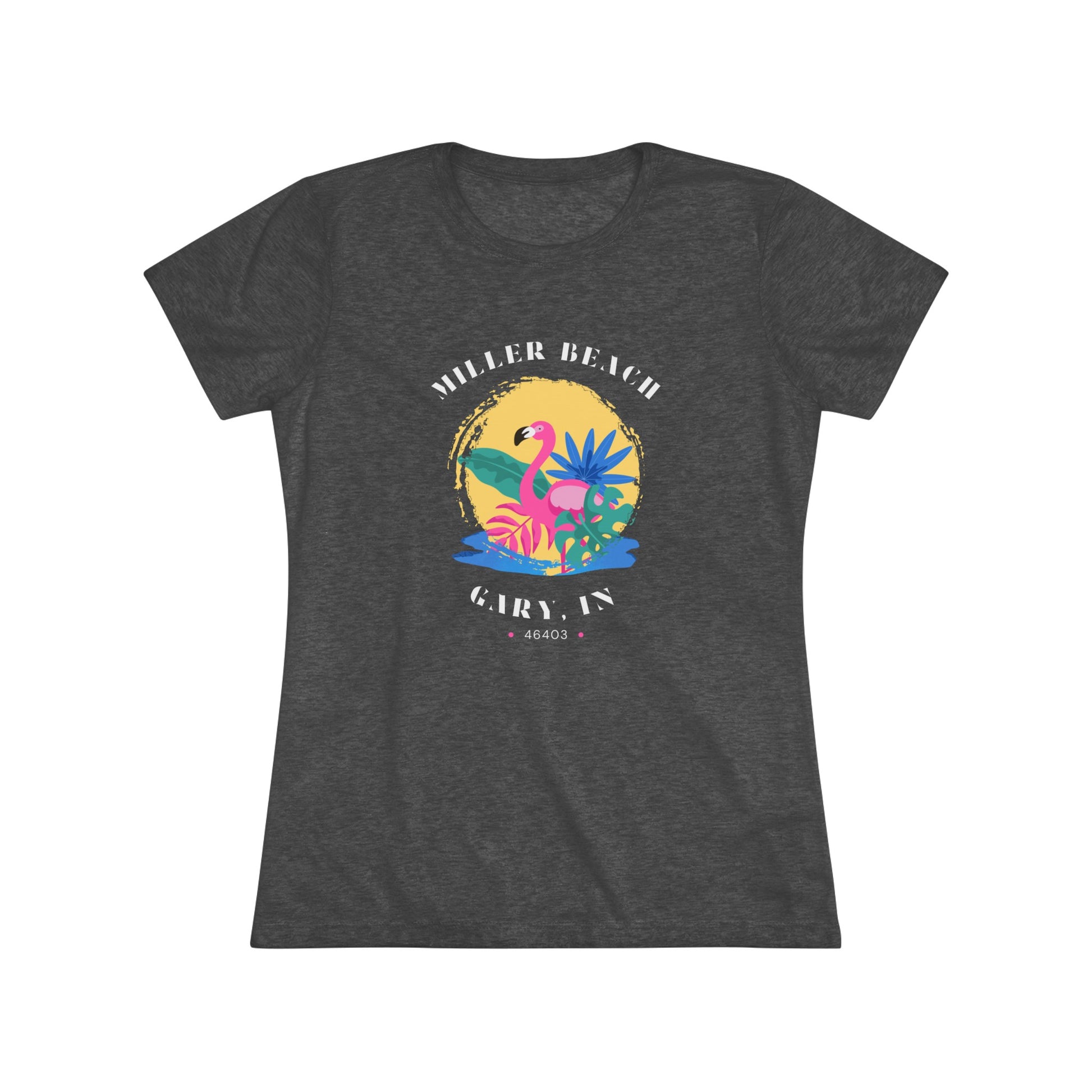 A women's triblend tee from Printify, the Miller Beach Flamingo features a blue color and "Miller Beach Gary, IN 46403" text with a vibrant design of a flamingo amidst tropical foliage for a vintage aesthetic. This t-shirt is showcased on a wooden surface alongside a denim jacket, white sneakers, and a potted plant.