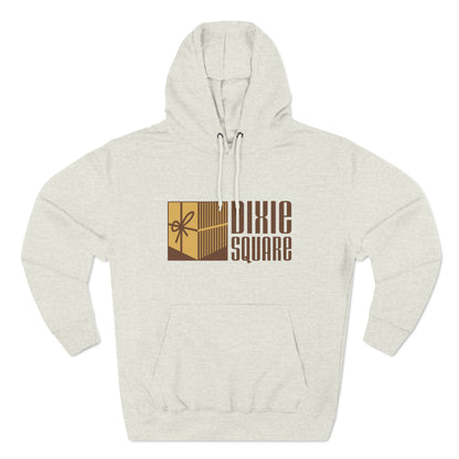 A black hoodie from Printify, named "Dixie Square 1960s Logo - Harvey, IL - Three-Panel Fleece Hoodie," featuring the words "Dixie Square" in brown stylized block letters on the front. Embracing a retro charm, the design also includes a graphic of a gold-colored square with a scissors icon and vertical lines, reminiscent of Dixie Square Mall's heyday.