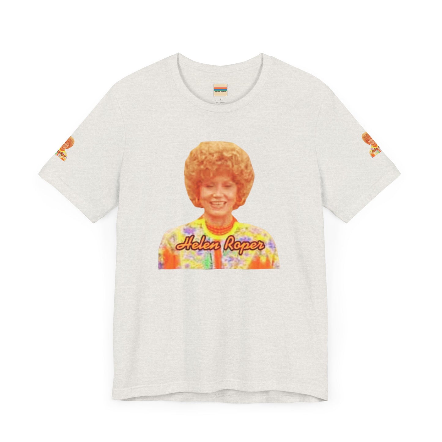 A lavender-colored Helen (Mrs.) Roper Three's Company - Unisex Jersey Short Sleeve Tee by Printify is hanging on a wooden hanger against a white background. This T-shirt features an image of a smiling person with curly hair wearing a colorful blouse, with the text "Helen Roper" underneath the image. Both sleeves have identical designs, making it perfect Three's Company merchandise.