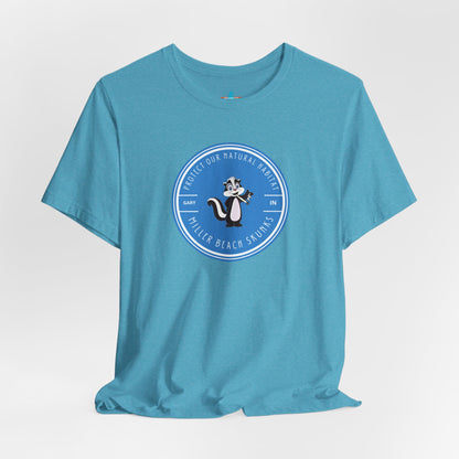 The Printify Miller Beach Skunks - Unisex Jersey Short Sleeve Tee is a gray T-shirt that features a circular blue logo at the center. Inside the logo, there is an illustration of a skunk with the text "Protect Our Habitat" and "Miller Beach Skunks" around the border, promoting environmental consciousness. The upper left part of the logo reads "Gary, IN.