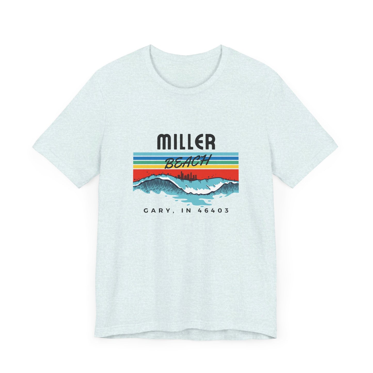 The Miller Beach 46403 Surf Style - Unisex Jersey Short Sleeve Tee by Printify features a retro surf-inspired design on a yellow background. The shirt displays "MILLER BEACH" above waves with a skyline illustration, while "Cary, IN 46403" is printed below the waves. The vibrant design also includes colorful stripes in shades of blue, red, and orange.