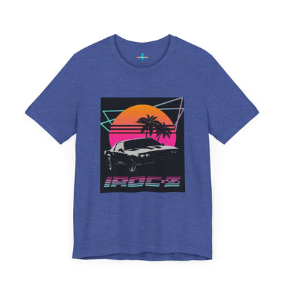 A Chevrolet Camaro iRoc Z Z28 T-Shirt 1980's by Printify, featuring a retro design with a black car, palm trees, and a sun setting in the background. The design includes geometric lines in neon colors and the text "IROC-Z" at the bottom, perfect for fans of the 1980s Chevy Camaro.