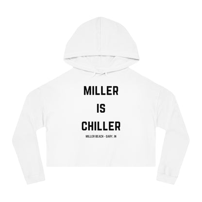 A white Women's Cropped Hooded Sweatshirt by Printify, featuring the phrase "MILLER IS CHILLER" printed in bold black letters on the front. Below the phrase, it says "MILLER BEACH • GARY, IN" in smaller black text. The SoCool Shirts hoodie includes a drawstring hood and long sleeves.