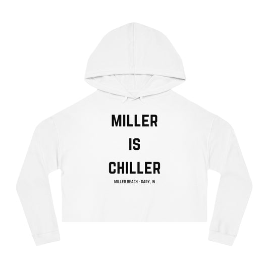 A white Women's Cropped Hooded Sweatshirt by Printify, featuring the phrase "MILLER IS CHILLER" printed in bold black letters on the front. Below the phrase, it says "MILLER BEACH • GARY, IN" in smaller black text. The SoCool Shirts hoodie includes a drawstring hood and long sleeves.