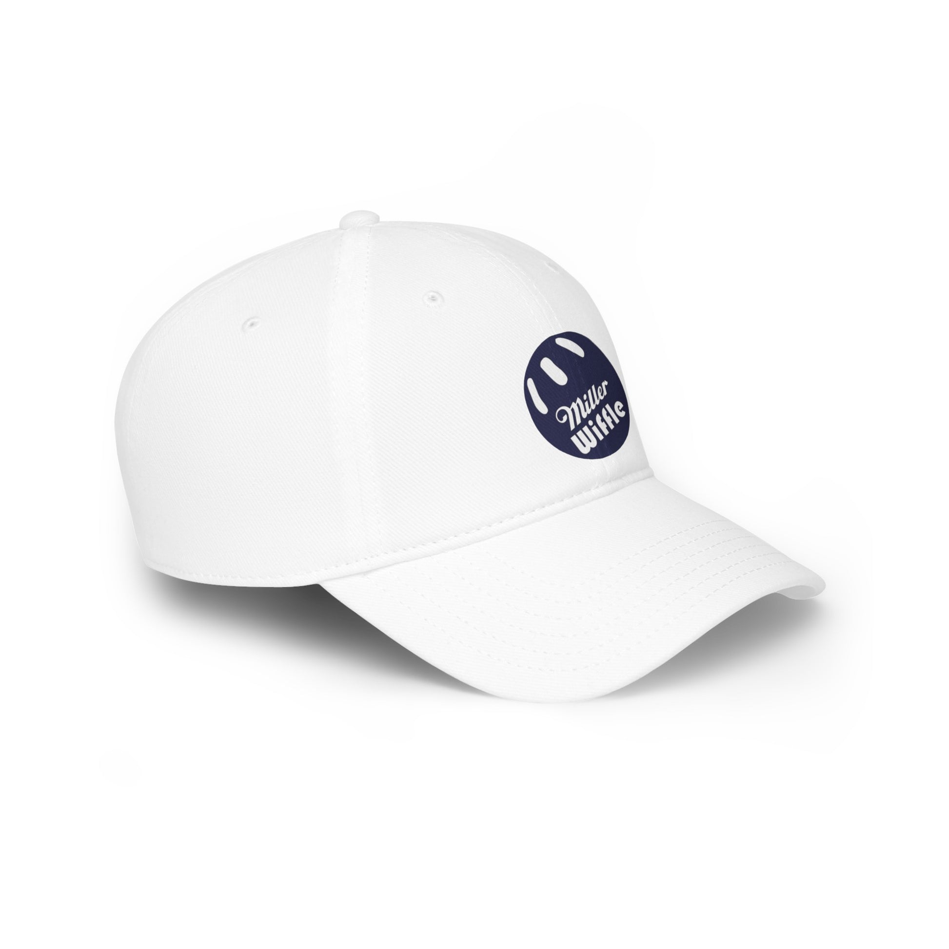 A person with long blonde hair smiles while wearing the Miller Beach Wiffel Ball - Low Profile Baseball Cap by Printify. The cap, crafted from 100% cotton, is white with a navy blue circular logo that reads "Miller Wiffle." The individual is also dressed in a light grey t-shirt, set against a plain white background.