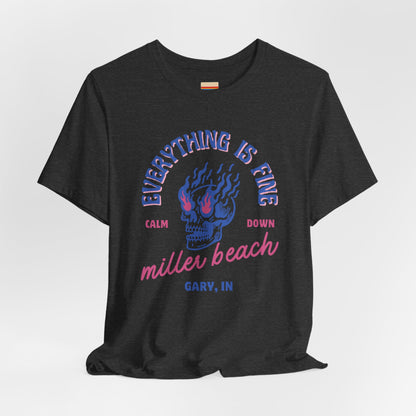 The Miller Beach Calm Down Everything is Fine - Unisex Jersey Short Sleeve Tee from Printify, crafted from soft Airlume combed cotton, showcases a peach-colored design with a flaming skull in the center. Above the design, it reads "Everything is fine," and below it says, "Calm down Miller Beach." In smaller text at the bottom, it reads "Gary, IN.