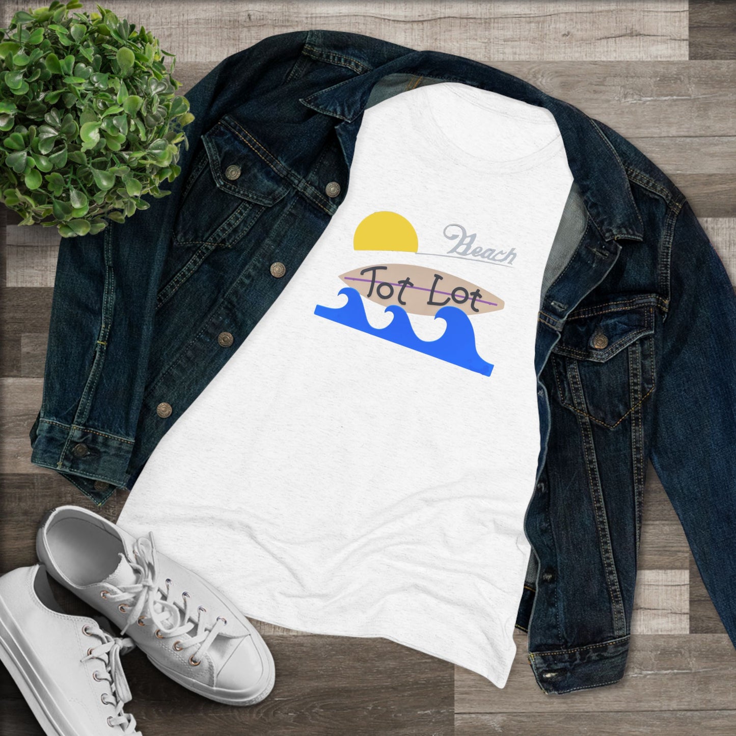 Introducing the Tot Lot Full Sign - Miller Beach - Women's Triblend Tee by Printify! This stylish gray t-shirt features a vintage-inspired design showcasing a setting sun, a surging blue wave, and the phrase "Miller Beach Tot Lot" in eye-catching stylized fonts. Perfect for any casual outing, this beach-themed top exudes a playful and trendy vibe.