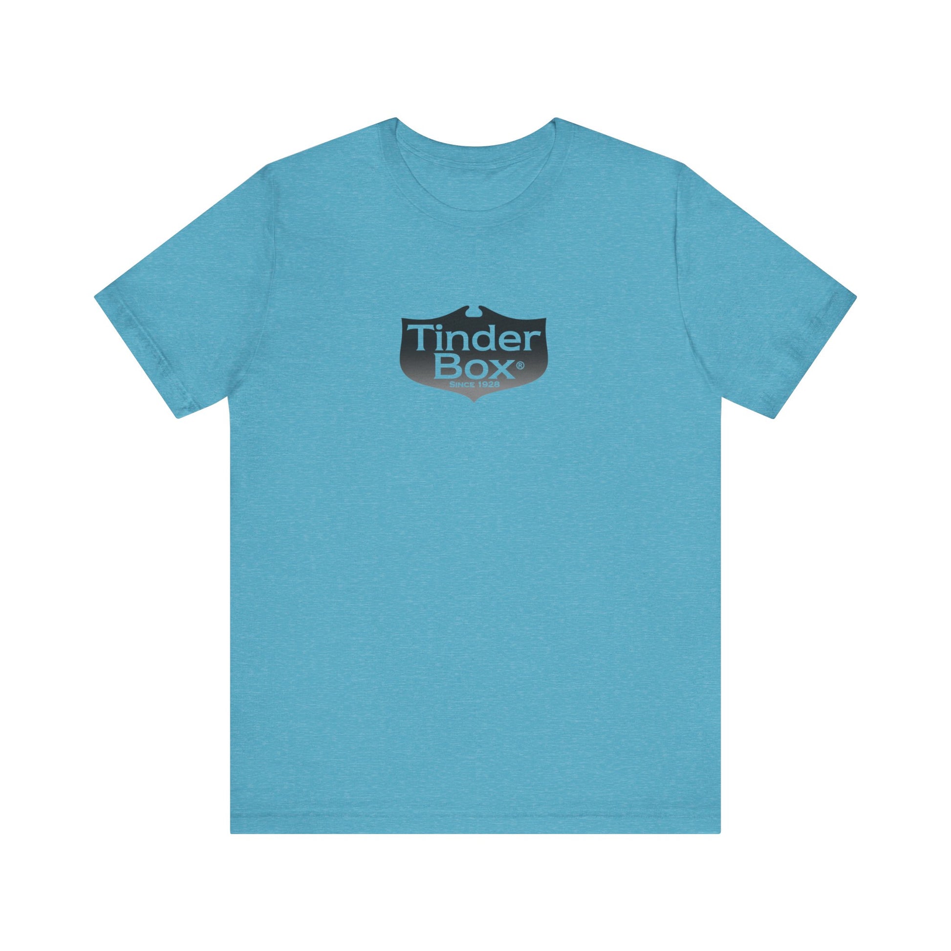 A light blue Printify "The Tinder Box 1980s" unisex jersey short sleeve tee featuring the "Tinder Box" logo in the center. The logo consists of a dark shield with the words "Tinder Box" in white text, with a small flame icon replacing the dot above the "i".