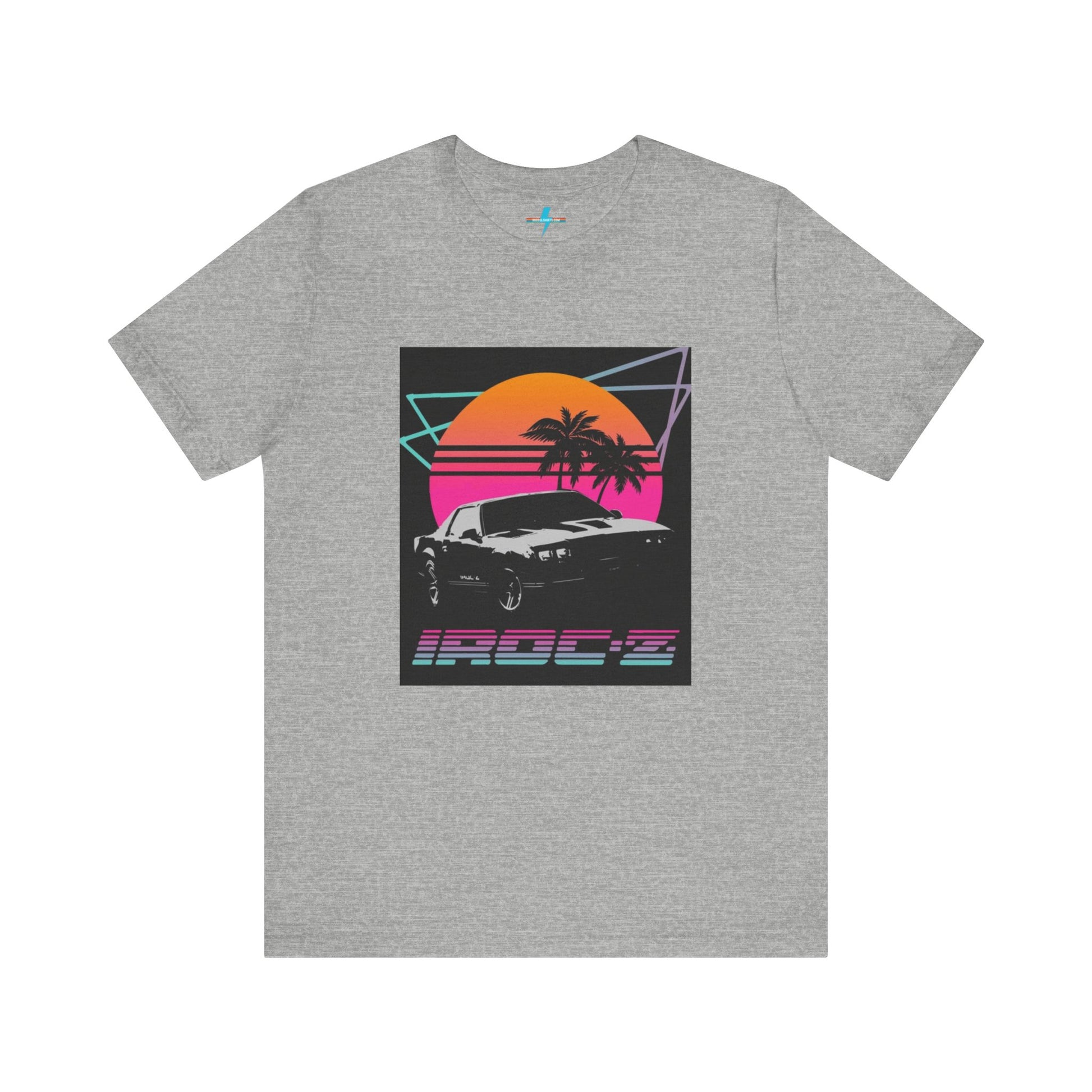 A Chevrolet Camaro iRoc Z Z28 T-Shirt 1980's by Printify, featuring a retro design with a black car, palm trees, and a sun setting in the background. The design includes geometric lines in neon colors and the text "IROC-Z" at the bottom, perfect for fans of the 1980s Chevy Camaro.