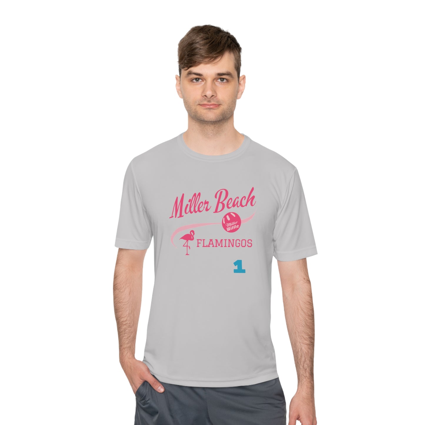 Introducing the "Miller Beach Flamingos - Jackson 01" Unisex Moisture Wicking Tee by Printify. This beige T-shirt showcases "Miller Beach" in a pink cursive font accompanied by a small pink flamingo illustration. Below, "FLAMINGOS" is displayed in bold pink capital letters, with a blue "01" on the bottom right corner. As part of the Sport-Tek PosiCharge Competitor collection, this lightweight shirt provides superior moisture-wicking performance.