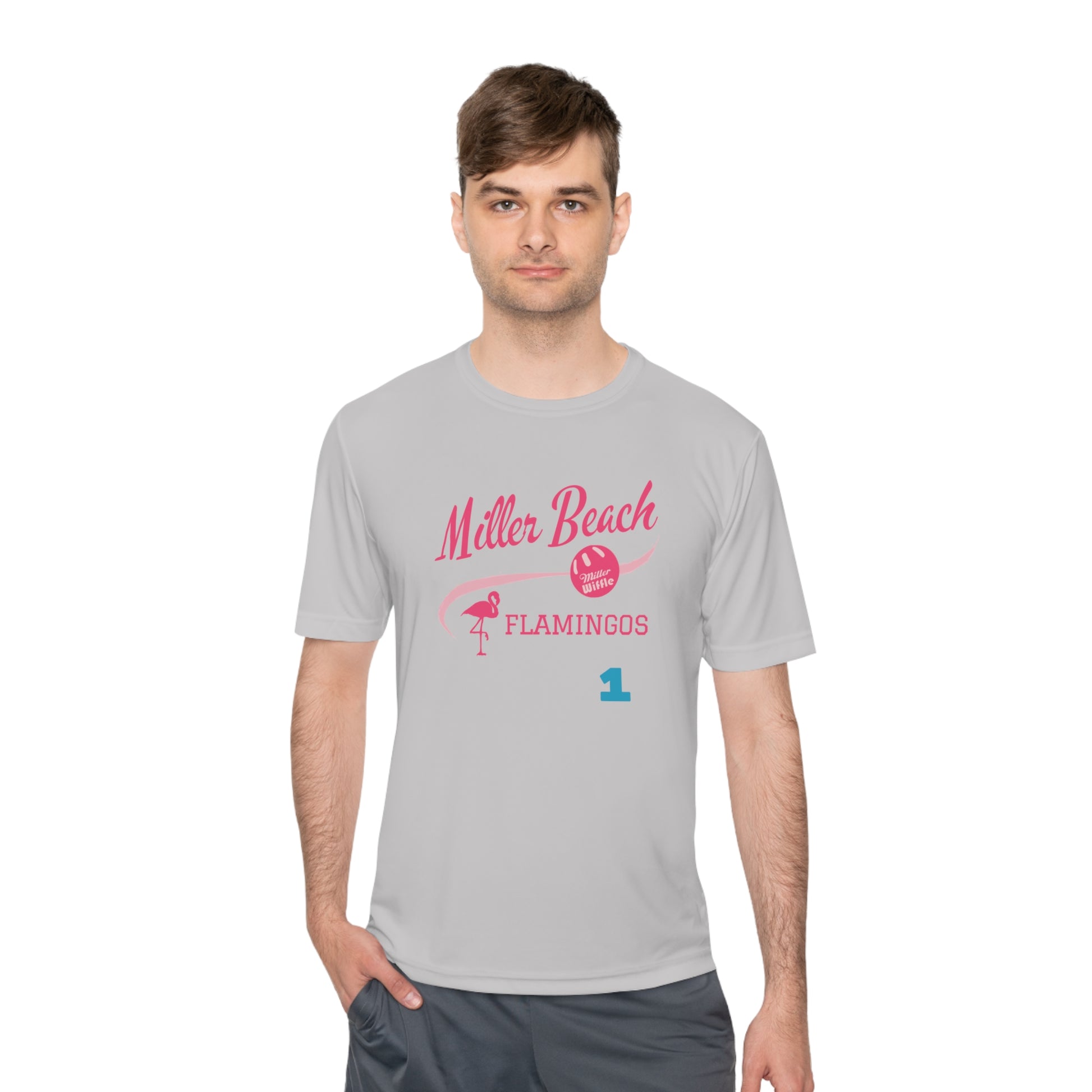 Introducing the "Miller Beach Flamingos - Jackson 01" Unisex Moisture Wicking Tee by Printify. This beige T-shirt showcases "Miller Beach" in a pink cursive font accompanied by a small pink flamingo illustration. Below, "FLAMINGOS" is displayed in bold pink capital letters, with a blue "01" on the bottom right corner. As part of the Sport-Tek PosiCharge Competitor collection, this lightweight shirt provides superior moisture-wicking performance.