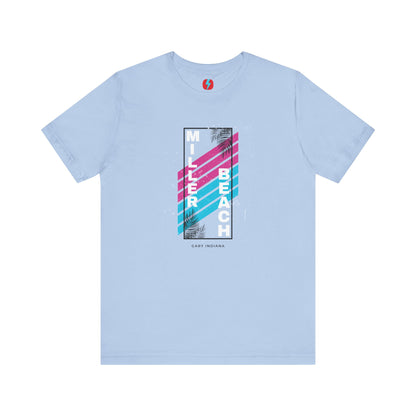 The Printify Miller Beach 1980s Style Unisex Jersey Short Sleeve Tee features a light blue base with retro-inspired diagonal stripes in blue and pink. "Miller Beach" is vertically displayed in white alongside black palm leaves, with "Gary Indiana" written at the bottom.