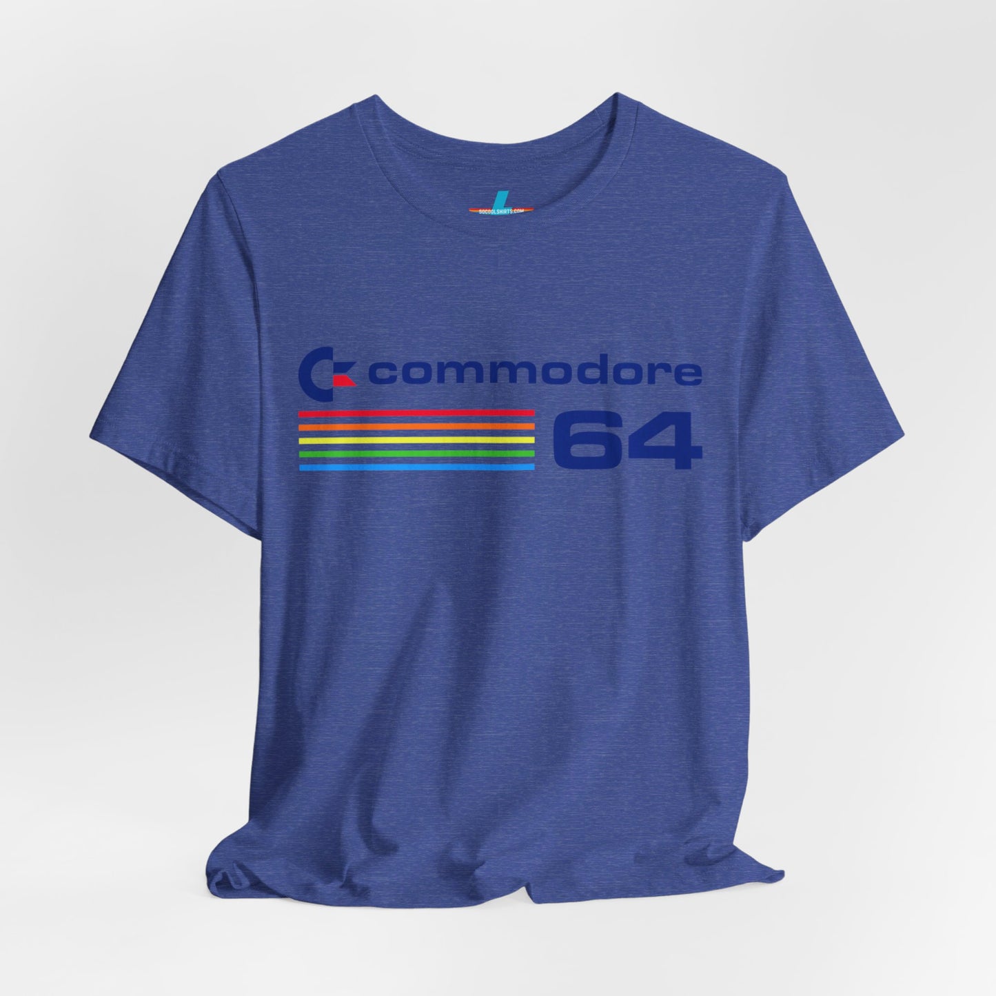 The 1980s Commodore 64 Computer C64 Unisex Jersey Short Sleeve Tee from Printify features a green T-shirt adorned with a vintage design showcasing the text "Commodore 64" and multicolored horizontal lines next to it. The word "Commodore" is emblazoned in blue alongside the Commodore logo, while the number "64" is also highlighted in blue on the right. Ideal for any retro tech enthusiast, this shirt is displayed against a white background.