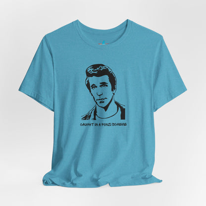 A white unisex jersey short sleeve tee by Printify, named "Caught in a Fonzi Scheme - Happy Days - Retro," features a black and white illustration of a person with a serious expression and styled hair, perfectly capturing the nostalgic apparel vibe. Below the illustration, the text reads "CAUGHT IN A FONZI SCHEME," making it an ideal Happy Days tribute shirt.