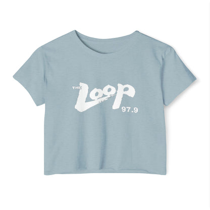 Printify's Women's Festival Crop Top features a grey design with short sleeves and a round neckline. The crop top displays the text "The Loop 97.9" in white, with the word "Loop" styled in a brushstroke-like font—ideal for fans of Chicago’s iconic rock radio station who appreciate retro fashion.