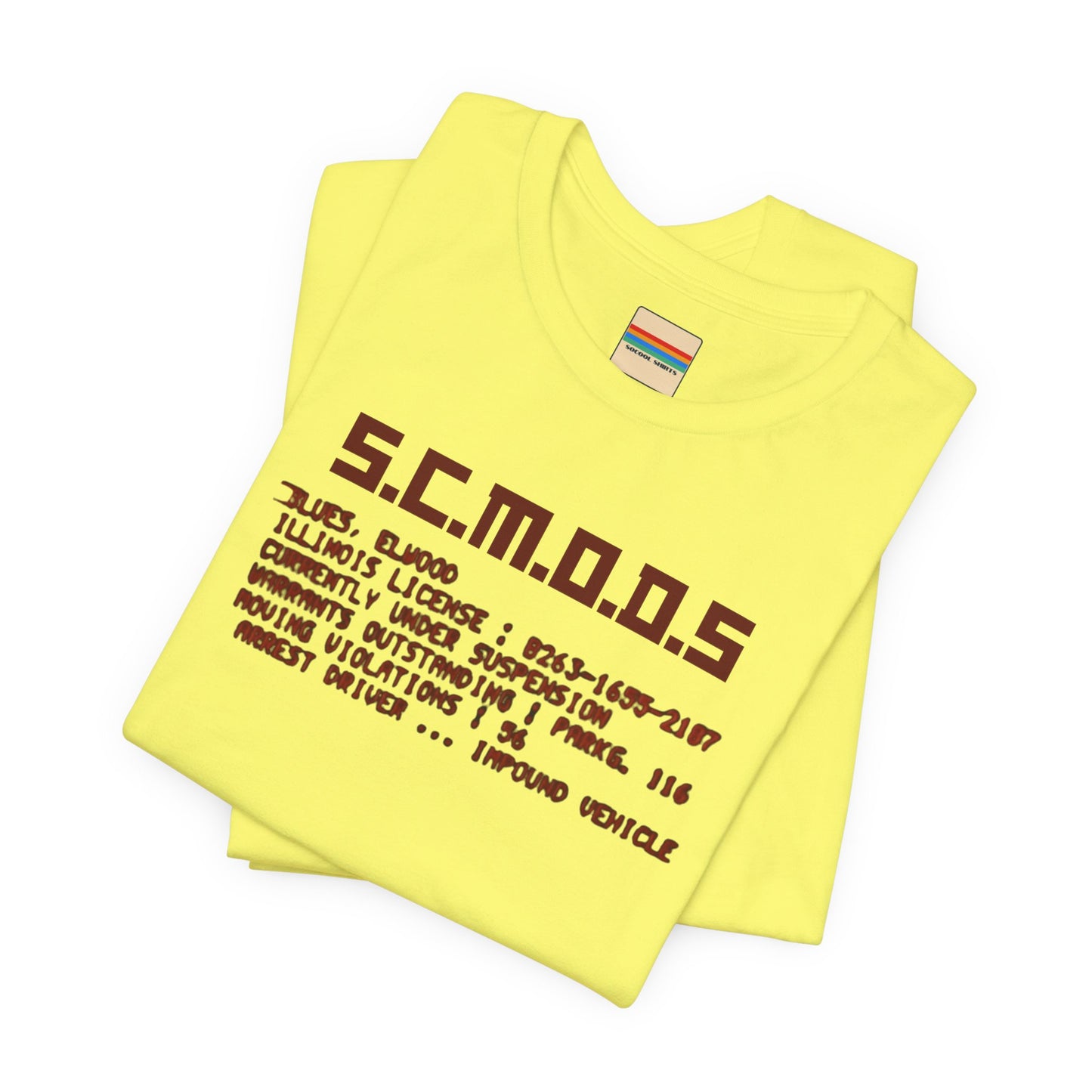 Two yellow "S.C.M.O.D.S. Blues Brother's - Unisex Jersey Short Sleeve Tee" shirts from Printify, featuring "S.C.M.O.D.S" in bold, stylized letters along with smaller text detailing terms like "Illinois," "license," and "impound vehicle." Perfect for fans of The Blues Brothers and Jake and Elwood Blues, the T-shirts are neatly folded and stacked.