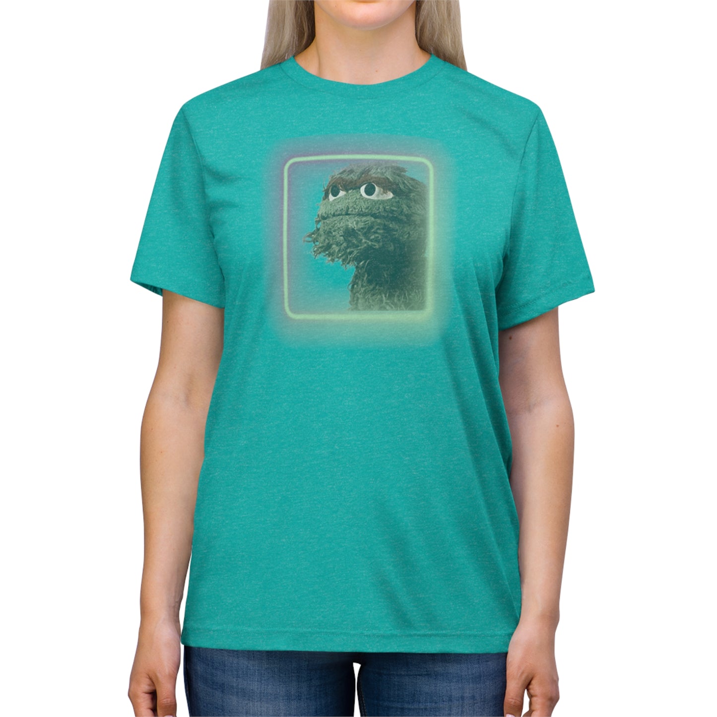 Introducing the Oscar the Grouch Unisex Triblend Tee by Printify: This red triblend t-shirt features a green puppet character with expressive eyes, framed by a glowing, square-shaped rainbow border. With its simple and casual design, free of any additional text or graphics, this tee offers the perfect blend of style and durability thanks to its polyester construction.