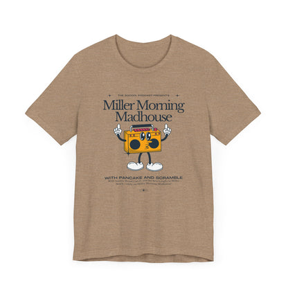 This Printify unisex jersey short sleeve tee in Sand Dune features a playful boombox cartoon character with arms, legs, and sunglasses. Emblazoned with "Miller Morning Madhouse," it highlights podcast details from "The School Podcast Presents.