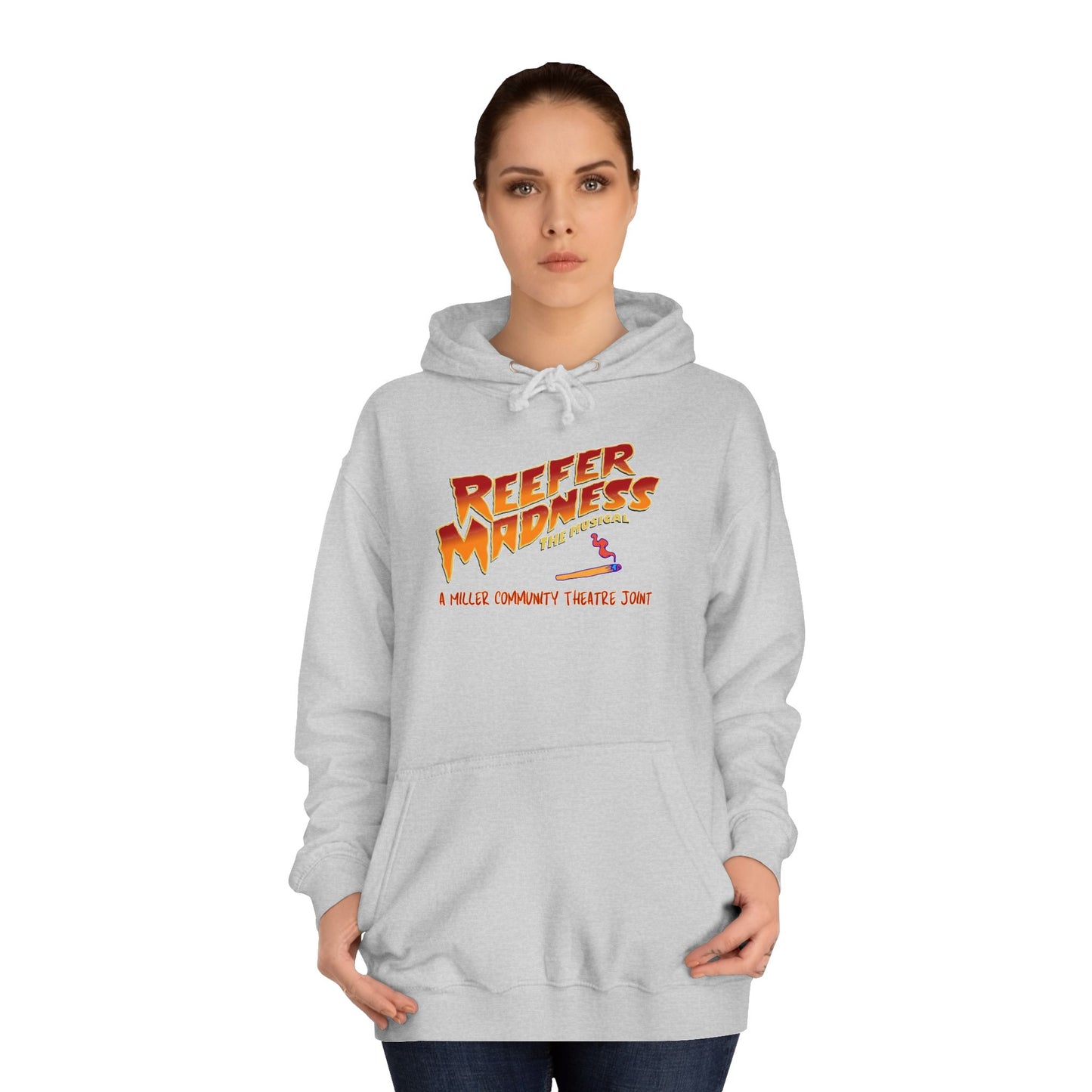 Introducing the "Reefer Madness - A Miller Community Theatre Joint" hoodie by Printify—a green hoodie with "Reefer Madness The Musical" displayed in bold, colorful font. Beneath it, the phrase "A very scary trip!" is featured. This hoodie is ideal for fans of the Miller Community Theatre production and comes with a front pocket and a drawstring hood.