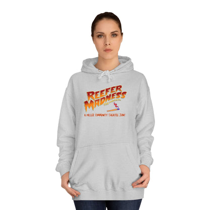 Introducing the "Reefer Madness - A Miller Community Theatre Joint" hoodie by Printify—a green hoodie with "Reefer Madness The Musical" displayed in bold, colorful font. Beneath it, the phrase "A very scary trip!" is featured. This hoodie is ideal for fans of the Miller Community Theatre production and comes with a front pocket and a drawstring hood.