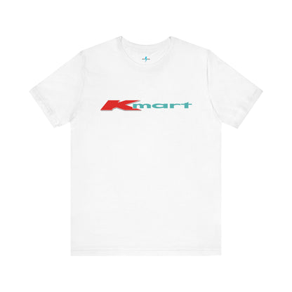 The Printify KMart Logo 1980s Retro - Unisex Jersey Short Sleeve Tee in dark gray features a nostalgic design with the iconic logo in red and teal across the chest. This short-sleeve crew-neck shirt exudes vintage charm with its simple, classic look.