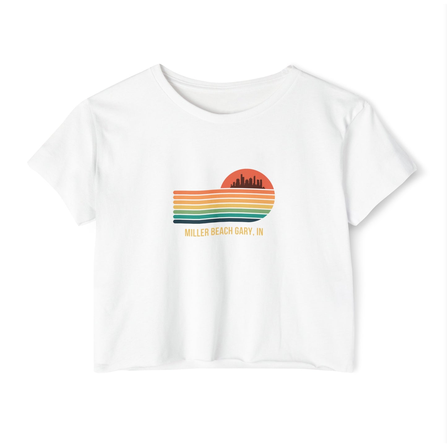 The Miller Beach Gary, IN Gradient Sunset - Women's Festival Crop Top by Printify is a mauve-colored T-shirt showcasing a retro-style graphic design of a sunset with multicolored stripes and a city skyline silhouette. Ideal for festival season, the text below reads "Miller Beach Gary, IN." Crafted to be soft and durable, this custom crop top provides both comfort and style throughout the day.