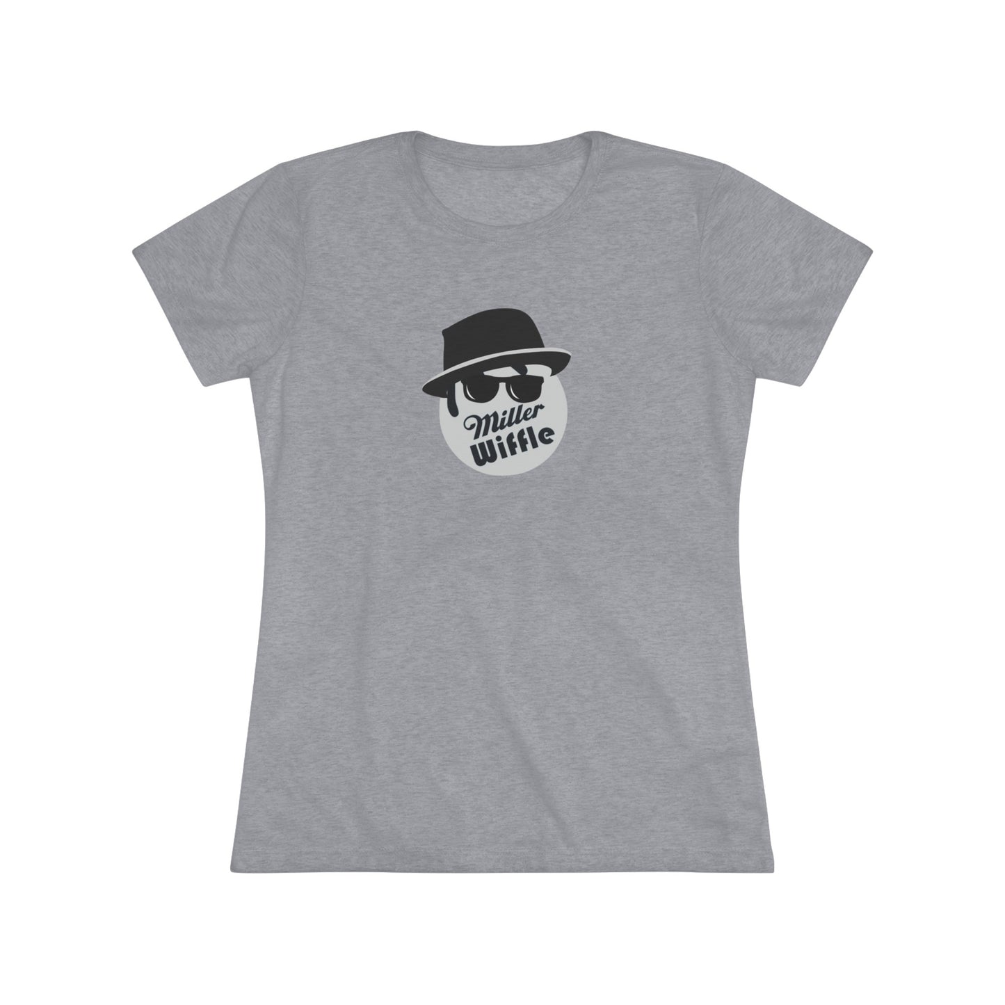 A cozy red t-shirt, the Miller Wiffel Ball - Blues Brothers - Women's Triblend Tee by Printify, features a graphic of a masked face wearing a fedora hat and sunglasses, along with the text "Miller Wiffle." The t-shirt is displayed on a wooden floor, paired with a denim jacket, white sneakers, and a potted green plant to create a vintage look.