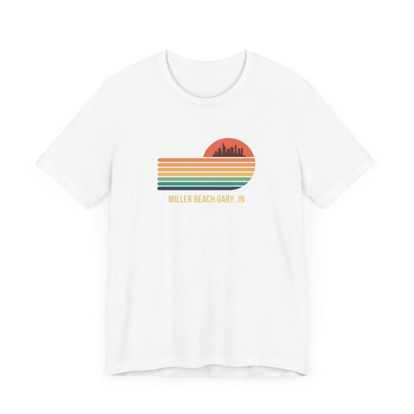 Introducing the Miller Beach Gary, IN Sunset Gradient - Unisex Jersey Short Sleeve Tee by Printify. This stylish blue T-shirt features a circular sunset graphic on the chest, showcasing a black city skyline silhouette against an orange-red sunset with horizontal stripes in green, yellow, and orange. Below the graphic reads "MILLER BEACH GARY, IN." Crafted from soft cotton for extra beachy charm.