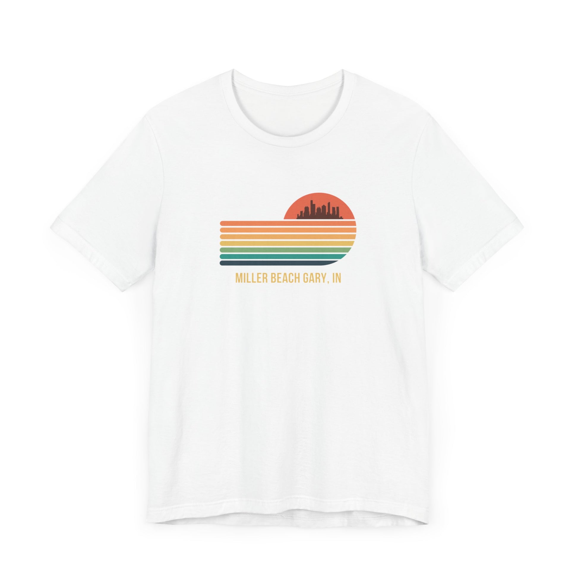 Introducing the Miller Beach Gary, IN Sunset Gradient - Unisex Jersey Short Sleeve Tee by Printify. This stylish blue T-shirt features a circular sunset graphic on the chest, showcasing a black city skyline silhouette against an orange-red sunset with horizontal stripes in green, yellow, and orange. Below the graphic reads "MILLER BEACH GARY, IN." Crafted from soft cotton for extra beachy charm.